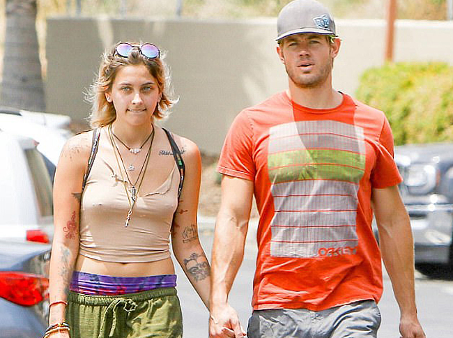 Paris Jackson walks braless in brown t-shirt while holding hands with Trevor Donovan