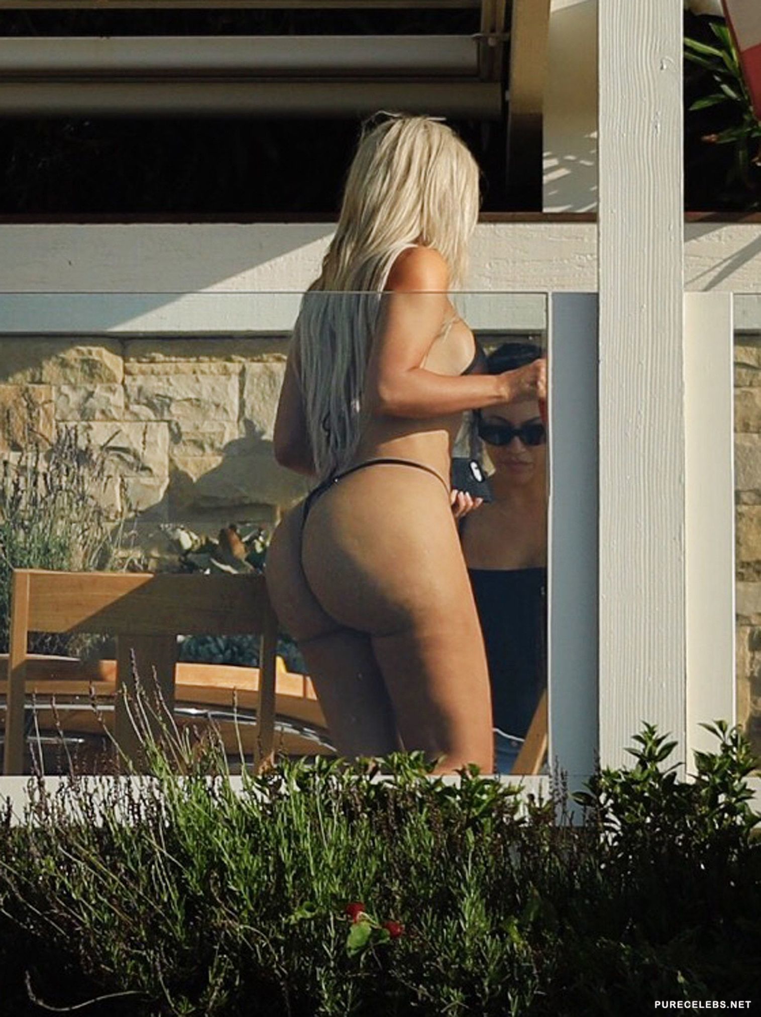 Kim Kardashian Sunbathing In Tihy Bikini On The Beach in Malibu image