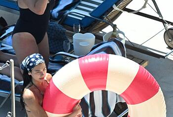 Dua Lipa sexy bikini on a beach